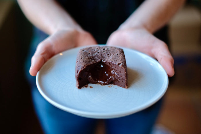 Molten Lava cake cut open and the chocolate flowing out of the centre