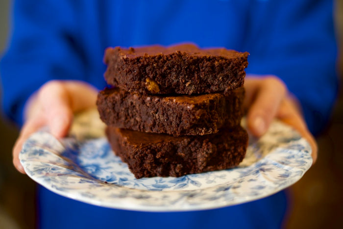 Brownies cut and stacked on top of one another, and ready to be eaten.