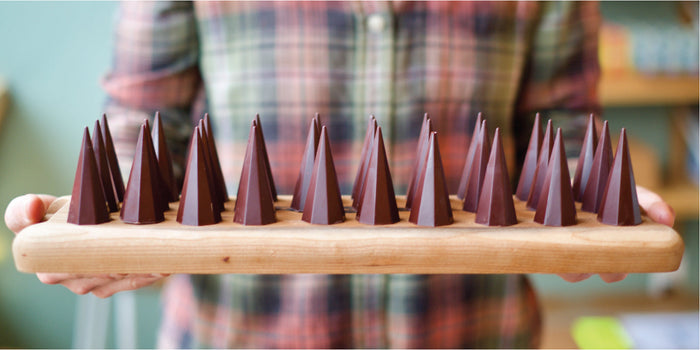 Dark chocolate peak truffles on a wooden crafted platter
