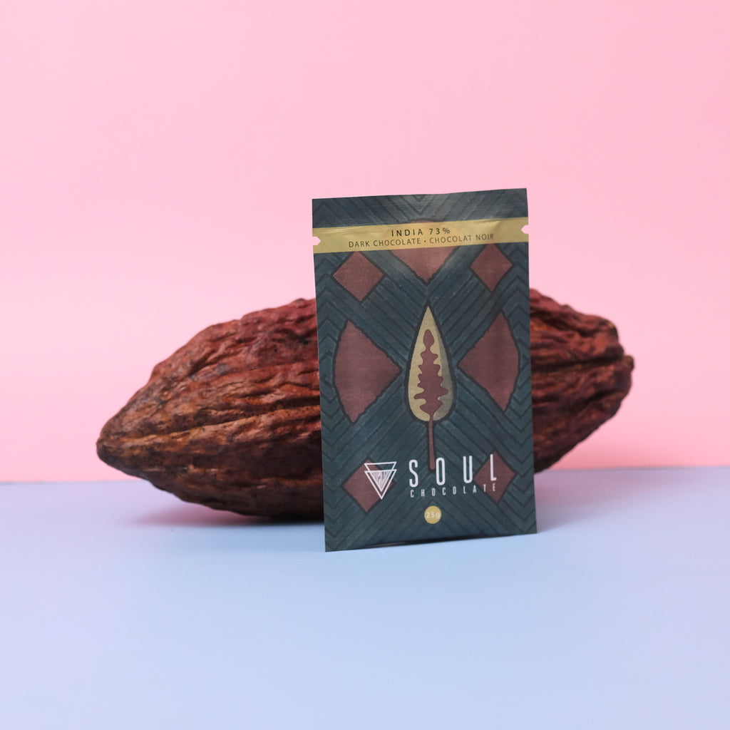 Soul Chocolate India dark chocolate bar packaging with a cacao bean on a pink and blue gradient background